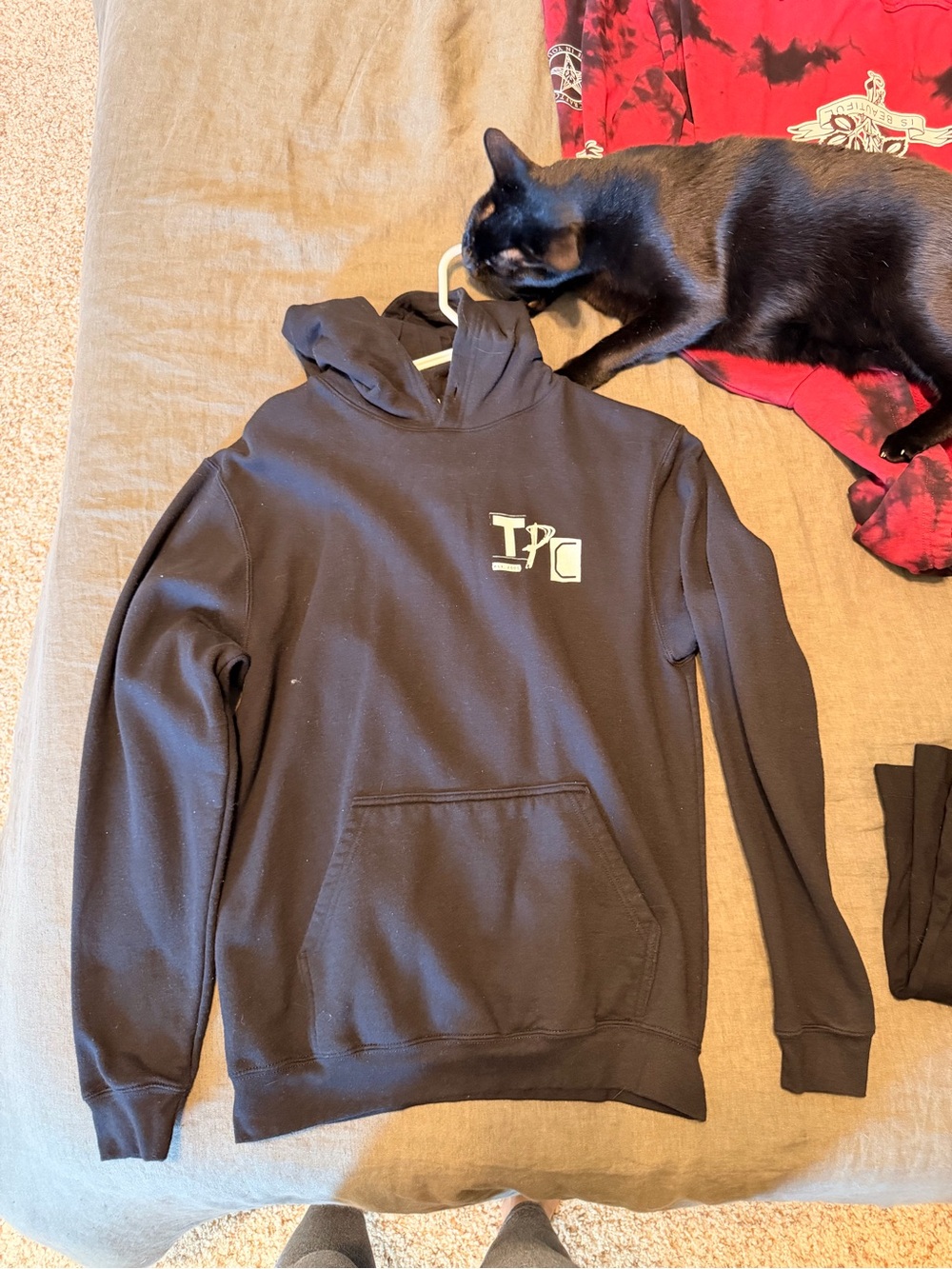 black hoodie with white 'TOKYO POLICE CLUB’ logo